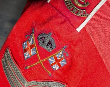 A Photograph featuring badges on the arm a military jacket