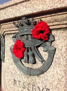The DCLI insignia on the Museum's memorial decorated with bright red knitted poppies