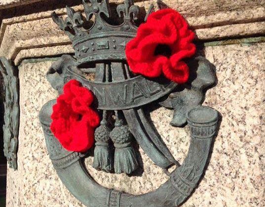 The DCLI insignia on the Museum's memorial decorated with bright red knitted poppies