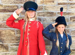 children dressing up in military uniforms