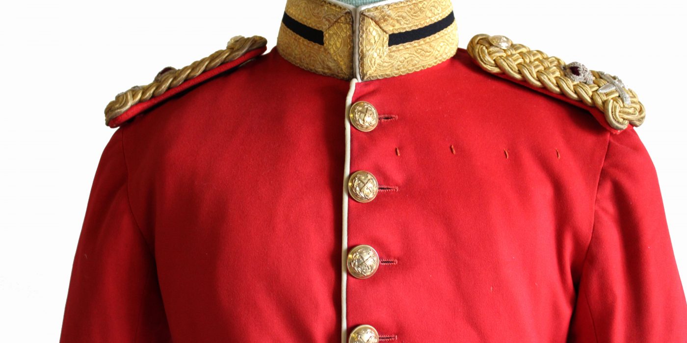 Red military jacket with gold buttons and shoulder epaulettes