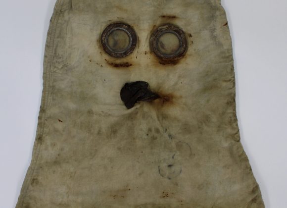 Early British gas mask with a hood that covers the whole head.