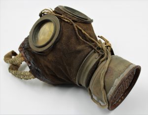 Brown leather gas mask with metal filterat front