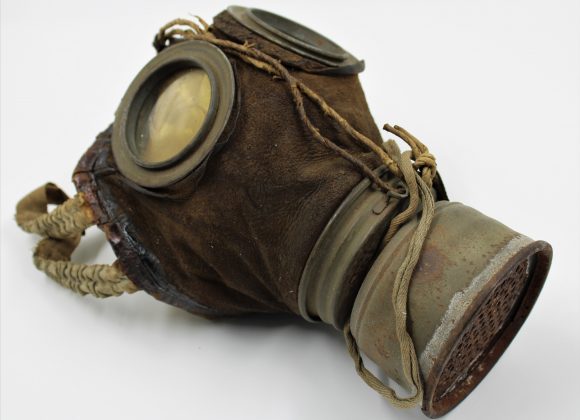 Brown leather gas mask with metal filterat front