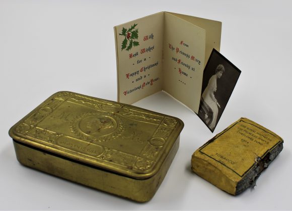Brass tobacco tin, small Christmas card, black and white photograph of Princess Mary and block of tobacco in yellow paper packet.