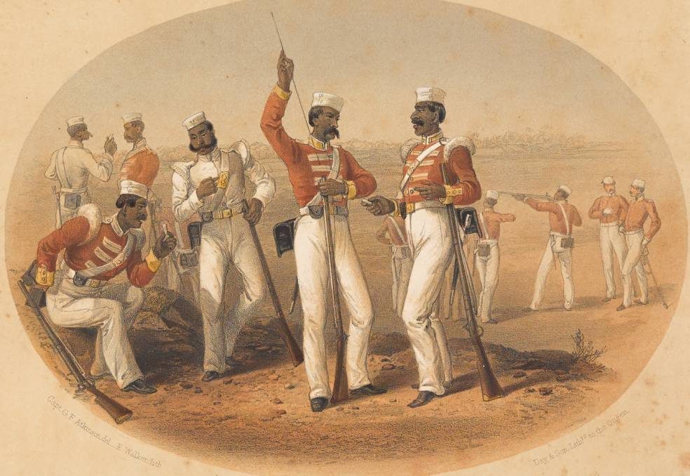 A group of Indian soldiers firing and loading rifles